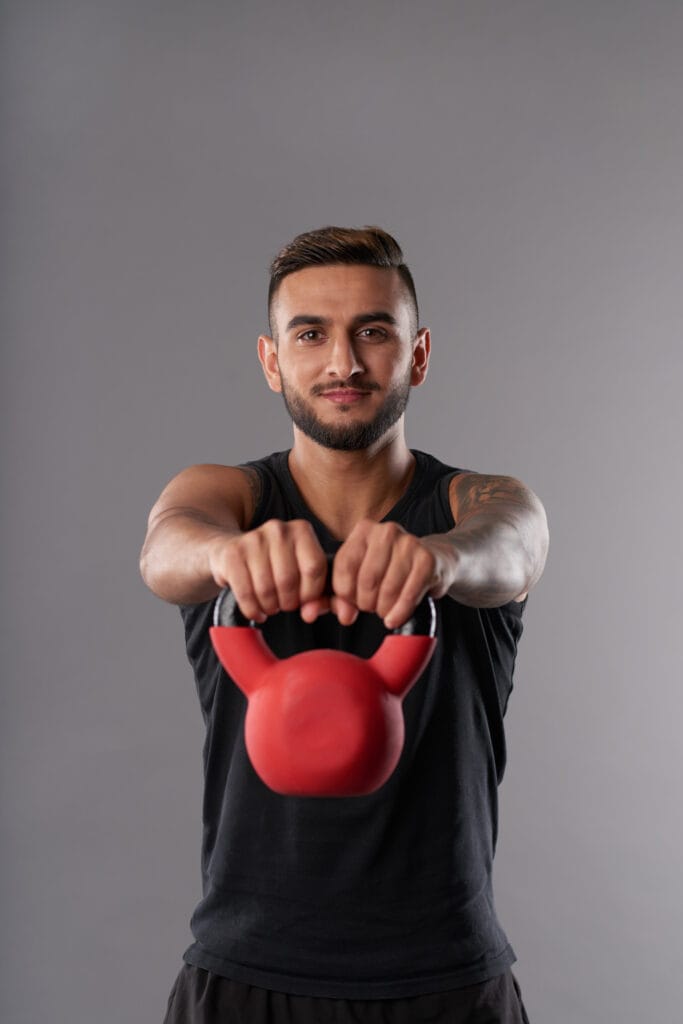 Young sportsman training with kettlebell Fitness