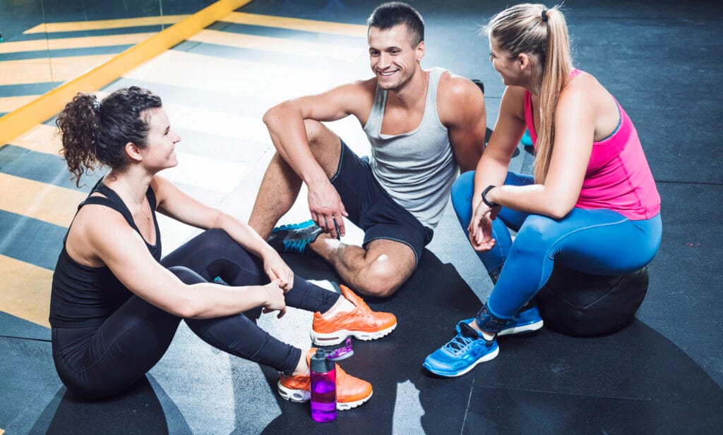 group-happy-athletic-people-sitting-floor-after-workout-health-club mindset support